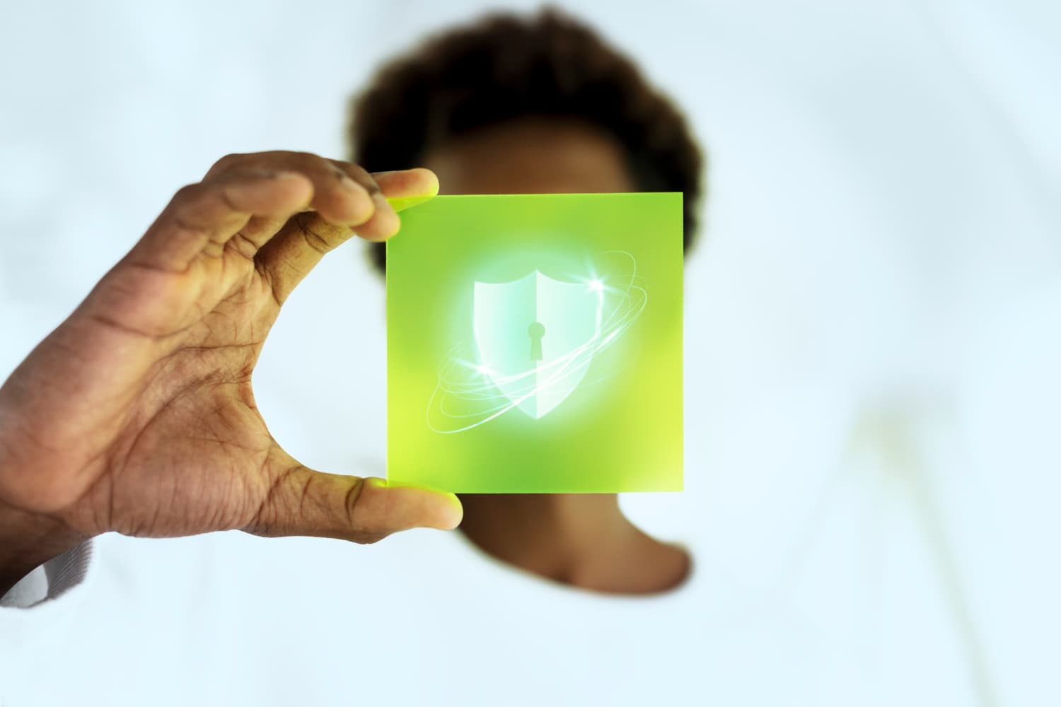 Person holding a security shield icon