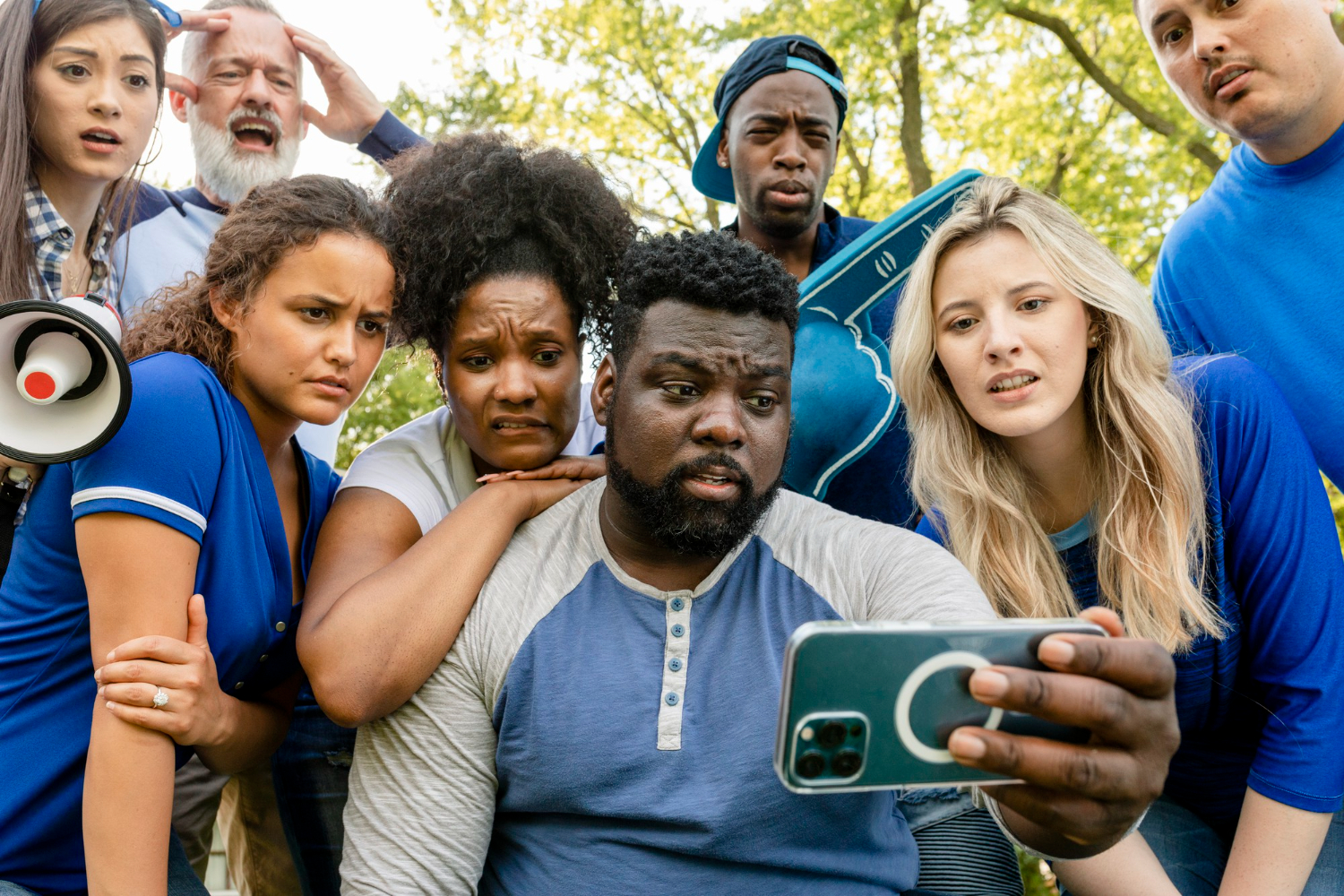 Group of diverse people looking at a smartphone