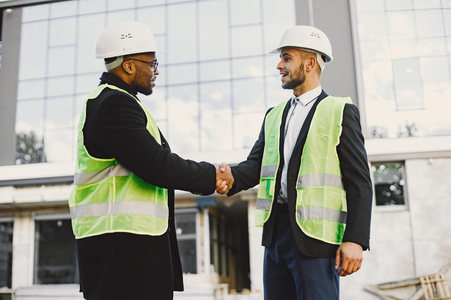 Professionals shaking hands on a construction site