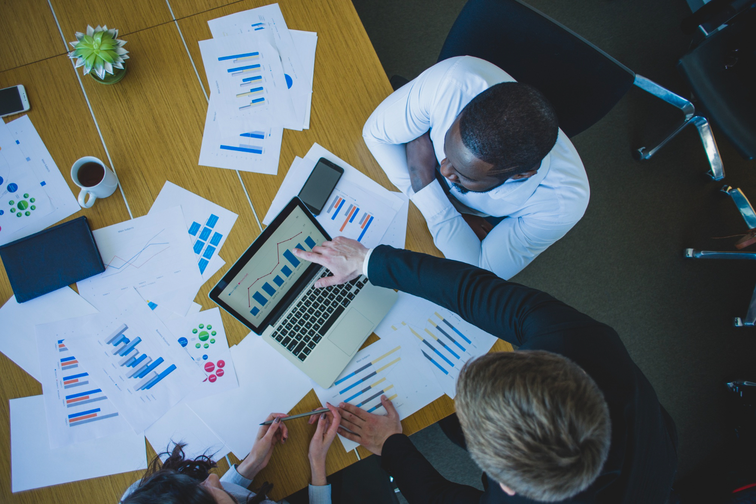 Professionals reviewing charts on a desk